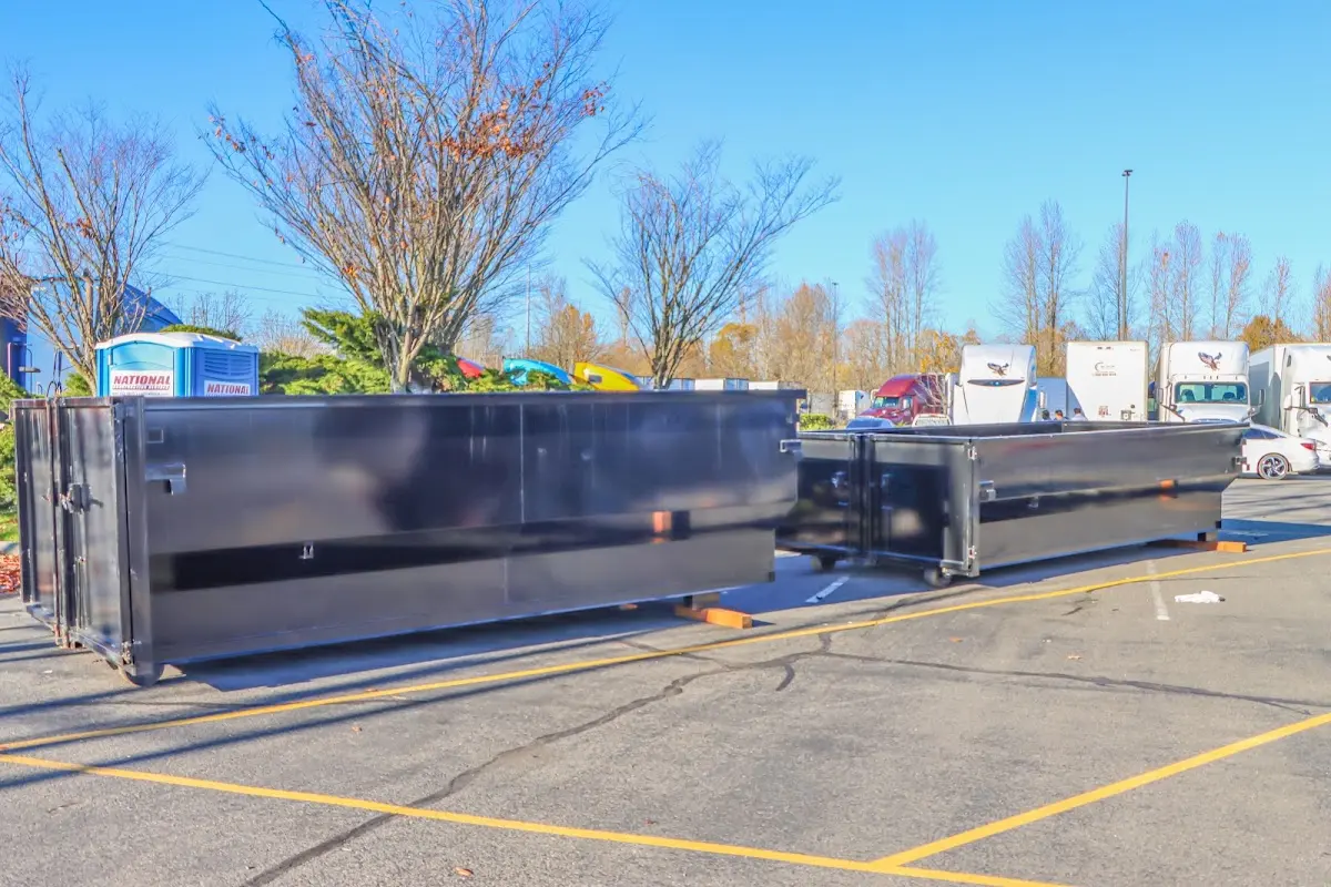 Professional dumpster rental service with roll-off container on residential driveway in Corona